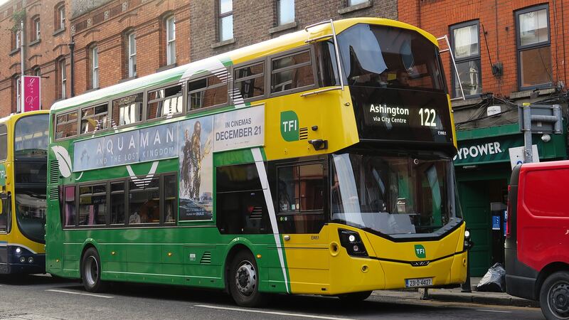 A green and yellow Dublin Bus electric double-decker in Dublin